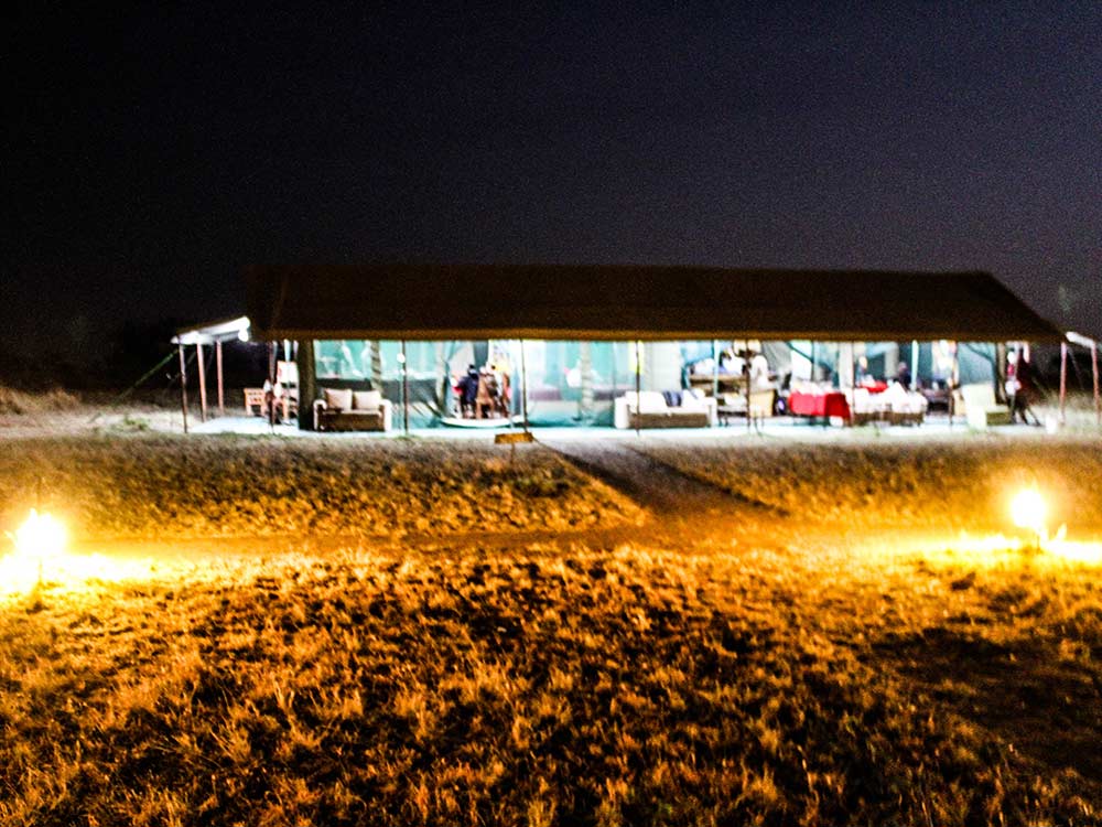 Camp mess tent lit up at night